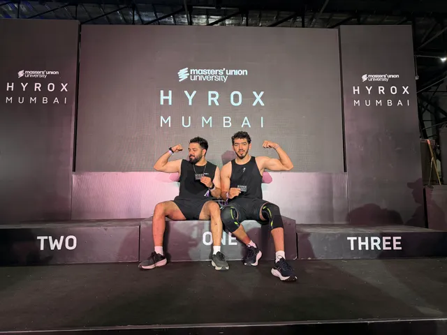 Two HYROX finishers holding their medals at the Mumbai event.